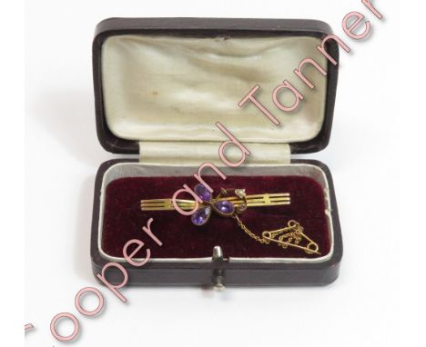 An amethyst and seed pearl bar brooch, in the form of a shamrock, stamped '9ct', 4.2g gross, cased