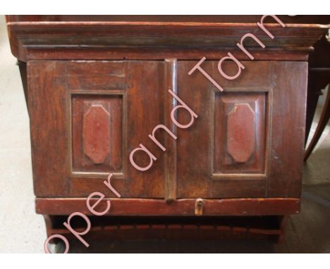 A 19th Century swedish painted pitch pine wall cabinet with moulded pediment, pair of panelled doors enclosing shelves and cu