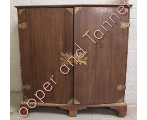 A 19th Century oak cabinet fitted with an array of 18 short drawers enclosed by a pair of doors with decorative Oriental moun