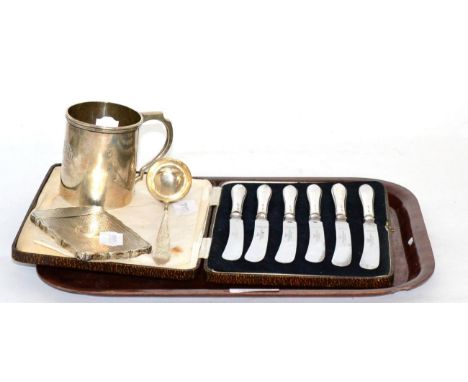 A group of silver comprising a Christening mug, card case, Scottish sauce ladle and a set of six silver handled tea knives  