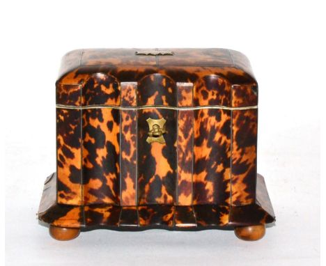 A regency tortoiseshell tea caddy, of fluted rectangular form, the hinged top concealing two lidded compartments, on a flared