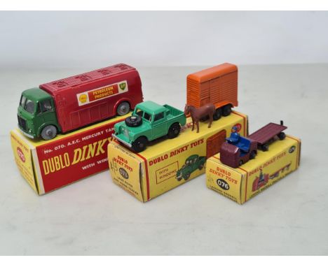 Three boxed Dublo Dinky Toys including 070 A.E.C. Mercury Tanker, 073 Land Rover and Horse Trailer and 076 Lansing Bagnall Tr