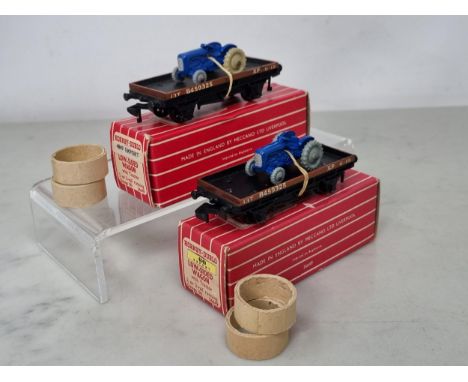 A reference pair of Hornby Dublo Export 4849 Low-sided Wagons with tractors, one tractor with rarer light grey wheels, differ