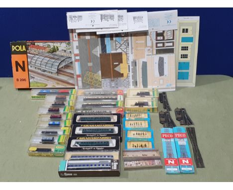 Two boxed Minitrix 12052 0-6-0T Locomotives, eighteen boxed Coaches and Wagons, four Superquick N scale Card Building Kits, a