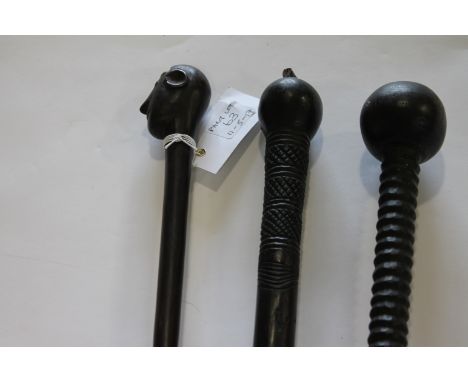 HARDWOOD STAFFS. Two carved Tribal Leaders or Elders hardwood staffs, also a carved slender staff. The first  of 89" in lengt