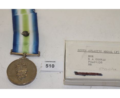 A SOUTH ATLANTIC MEDAL & ROSETTE TO A RM. A boxed South Atlantic Medal with rosette, named to Mne E A Conway P040125G RM. The