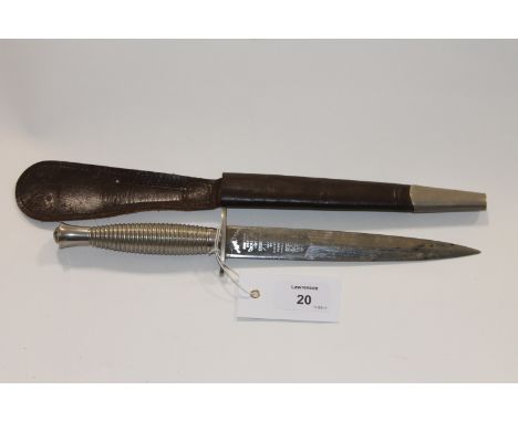 A COMMANDO DAGGER. A Wilkinson marked plated Fairburn-Sykes Commando Dagger, complete with its scabbard. 7" double-edged blad