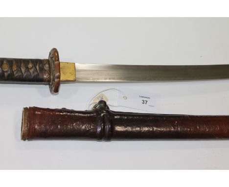A SHIN GUNTO KATANA. A Shin Gunto Katana with 25.3/4" blade, with an oil quenched temper line, complete with a leather covere