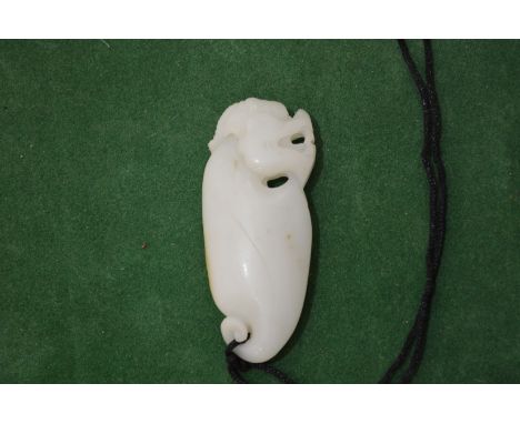 A Chinese carved white jade pendant.