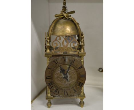 A small brass lantern clock.