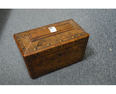 A Victorian figured walnut sarcophagus shaped tea caddy.