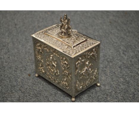 An Indian white metal tea caddy with hinged cover and embossed decoration.