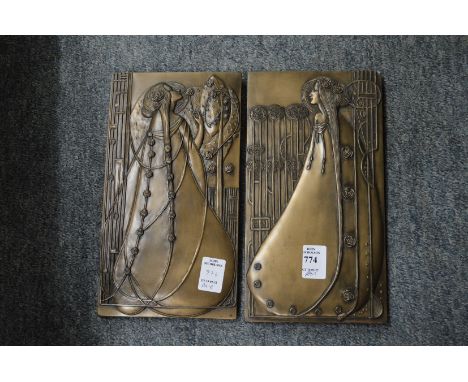 A pair of Art Nouveau style wall plaques.
