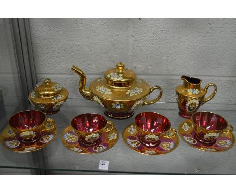 A continental gilt decorated ruby glass tea service.