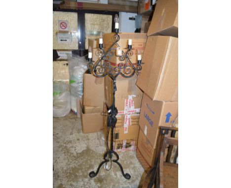A wrought iron standard lamp.