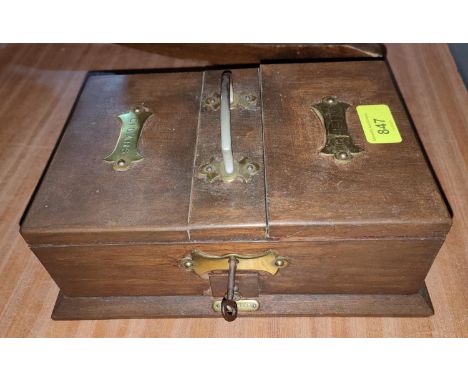 A smokers cabinet with brass bindings, cigarette, cigar and lighter sections 