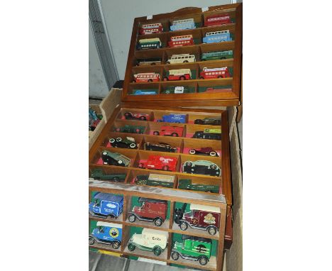 A selection of wall hanging display cases with diecast vehicles on inside and a collection of other larger scale vehicles 