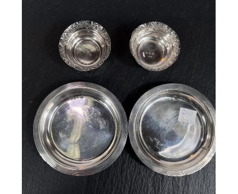 A pair of hall mark silver trinket dishes and a pair of silver salts 