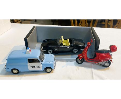 A Kyosho 1:18 scale diecast Police Mini Van; chrome 1:18&nbsp; Spitfire and a 1:12 scale Auto Art Scooter, all with boxes. 