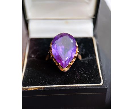 A yellow metal ring set large teardrop shaped amethyst, unmarked, tests as circa 18ct, size Q 