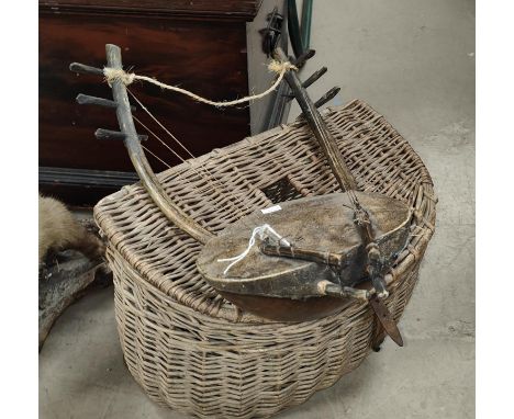 A vintage wicker Fisherman's basket and an unusual instrument