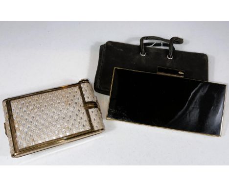 A vintage camera style combined compact with mirror, powder, rouge, lipstick, cigarette and matches sections; a similar black