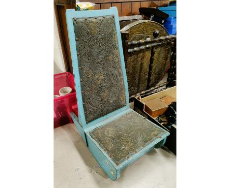 A vintage Arts and Crafts style child's blue rocking chair with hinge seat