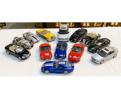 A selection of larger scale car models, including Burago, Aston Martin etc.&nbsp; 13 approximately. 