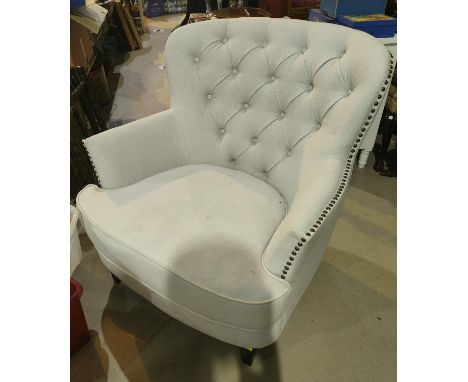 A traditional style semi-wing button back chair in cream fabric 