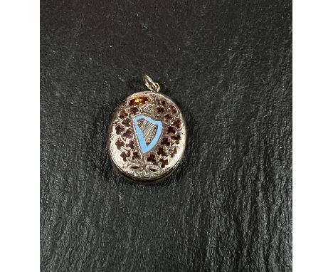 An Irish yellow metal locket with blue enamel harp surrounded by red enamel clovers