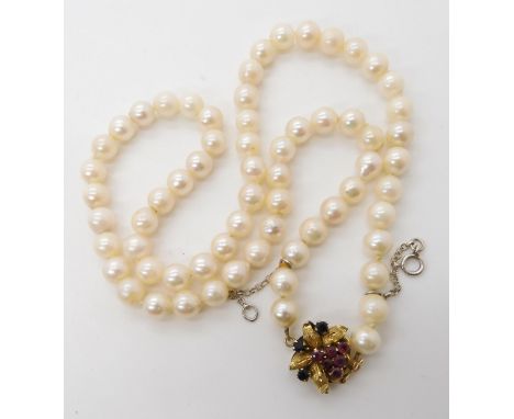 A string of cultured pearls with an unusual 14k gold ruby and sapphire clasp, each pearl approx 6.4mm, length 46cm, weight 30
