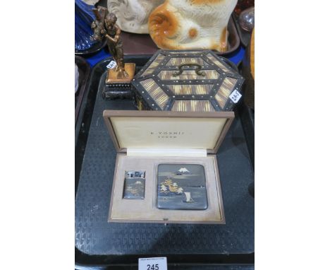 A Japanese metal cigarette case and lighter in box, named for K. Yoshii, Tokyo, a porcupine quill box and a small statue of a