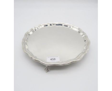 An Elizabeth II silver salver, with scalloped rim, on three ball and claw feet, by Charles S Green &amp; Co, Birmingham 1965,