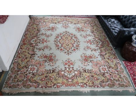 A 20th century light green ground Aubusson style rug with floral central medallion and matching borders, 322cm long x 273cm w