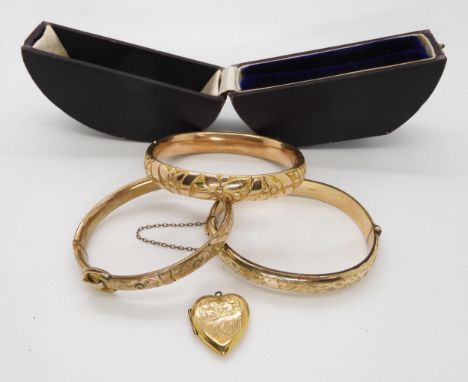 A boxed rolled gold bangle, a 9ct B&amp;F locket and two gold plated bangles Condition Report:Not available for this lot.