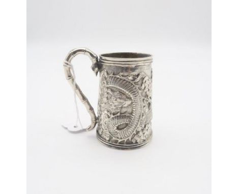 A Chinese export silver tankard, the body embossed with a dragon amongst clouds chasing a flaming pearl, the pearl monogramme