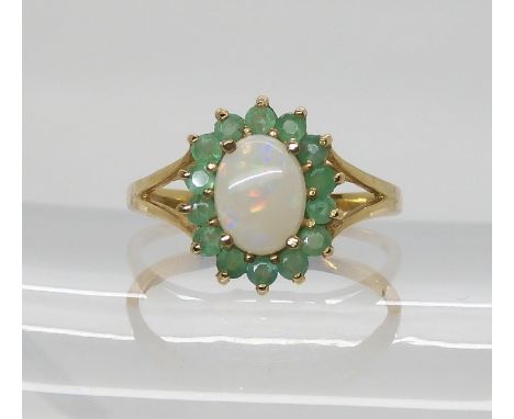 A 9ct gold opal and emerald cluster ring, size O, weight 2.2gms Condition Report:Available upon request