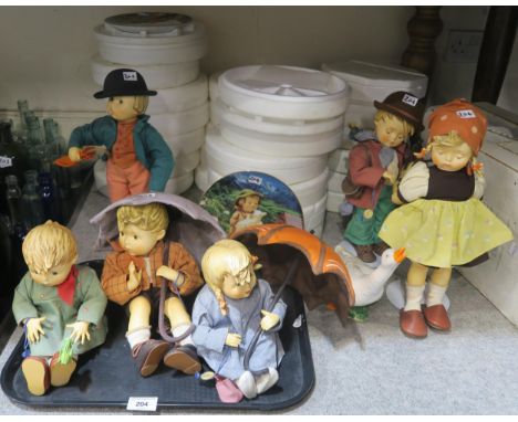 A collection of Hummel dolls including Goose Girl, Umbrella Boy and Girl and others and assorted Hummel wall plates Condition