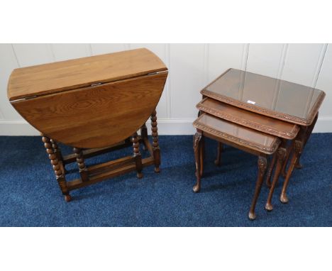 A 20th century mahogany nest of three tables and an oak drop leaf table with carved bobbin uprights (2) Condition Report:Avai