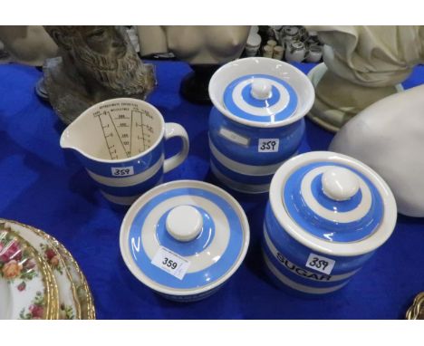 Four Cornish Ware pieces including two storage jars, butter dish and a jug Condition Report:Available upon request