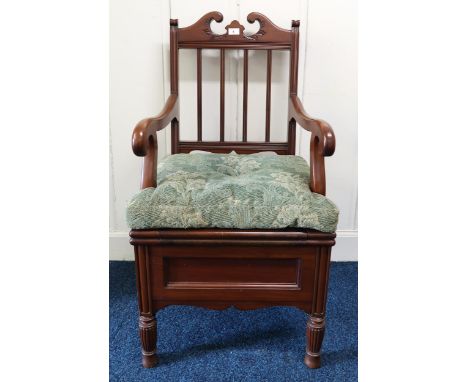 An early 20th century mahogany commode armchair with ceramic pot interior Condition Report:Available upon request