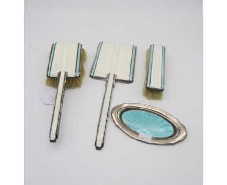 A three piece Art Deco silver, white and turquoise guilloche enamel dressing set, comprising clothes brush, hand brush and ha