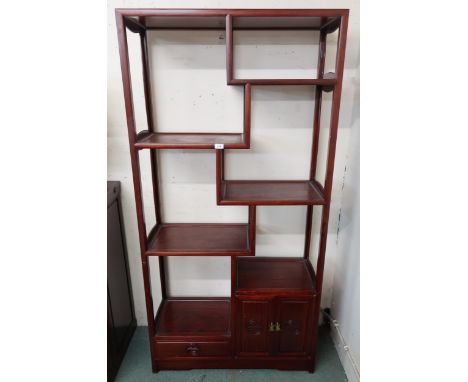 A modern Oriental style display shelf with four asymmetrical shelves above single drawer and cabinet doors, 182cm high x 91cm