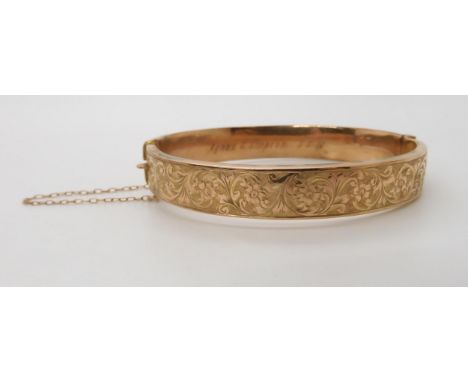 A 9ct gold bangle with hand engraved detail, weight 10gms Condition Report:Available upon request