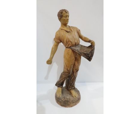 A Goldscheider figure of a man sewing grain Condition Report:Available upon request