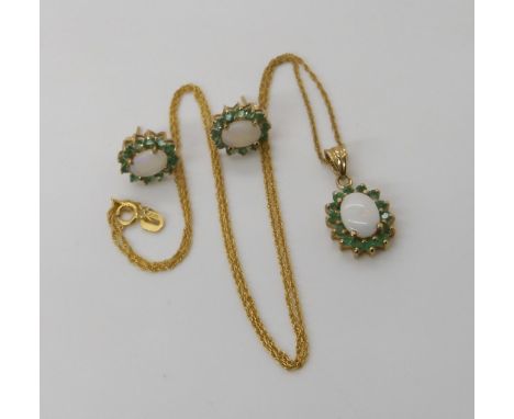 A 9ct gold opal and emerald pendant and matching earring set, weight combined 3.9gms Condition Report:Available upon request