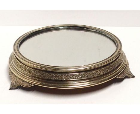 A silver plated and mirror topped plant stand.