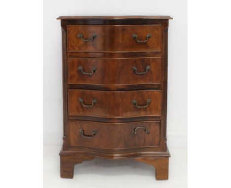 A 18th century style reproduction serpentine-fronted figured walnut and crossbanded chest of small proportions: the moulded t