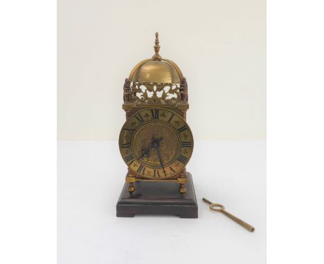 An early 20th century brass lantern clock modelled as a 17th century original:&nbsp; high arched domed top (as a bell) and pi