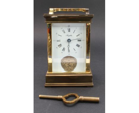 A gilt-metal and brass cased carriage clock: white-enamel dial with Roman numerals signed 'Angelus'; the underside engraved '